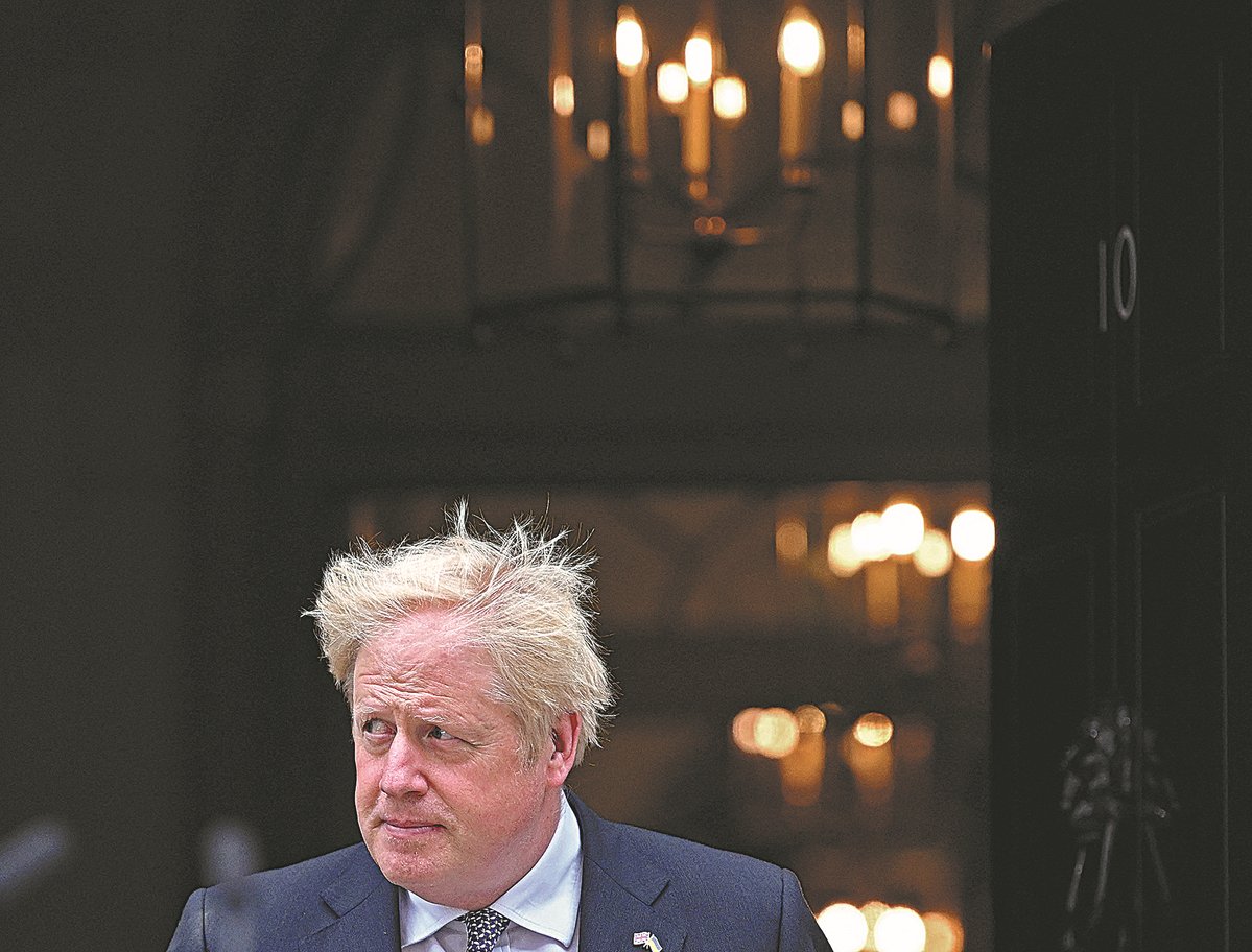 Britain's Prime Minister Boris Johnson makes a statement in front of 10 Downing Street in central London on Thursday. Johnson quit as Conservative Party leader, after three tumultuous years in charge marked by Brexit, COVID and mounting scandals.